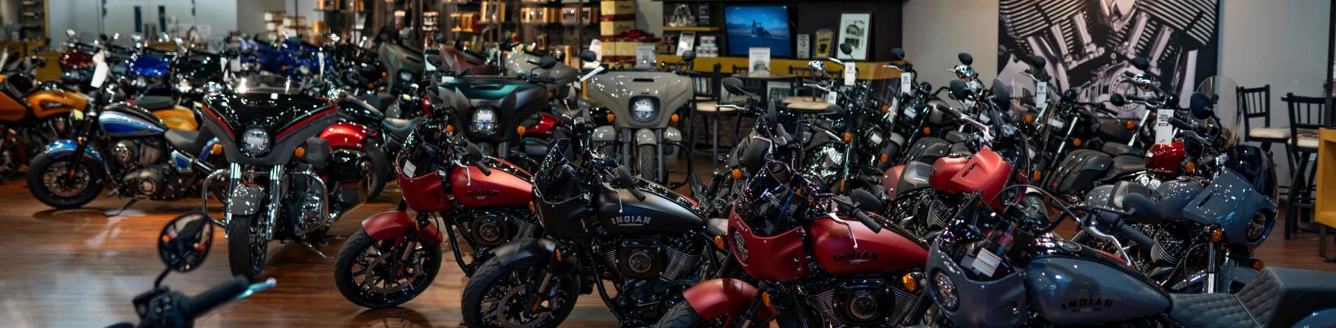 A picture from within a store with a lot of motorcyles in it